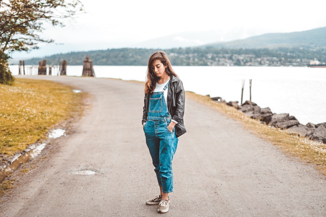 A worker wearing denim overalls